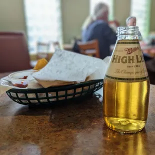 a bottle of beer and a basket of chips