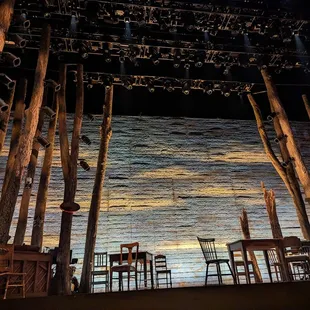 a stage with chairs and tables