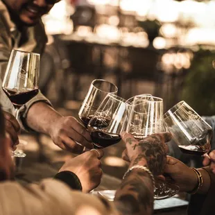a group of people clinking wine glasses