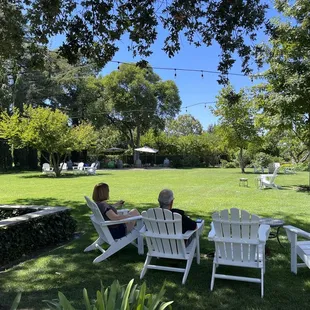 two people sitting in lawn chairs