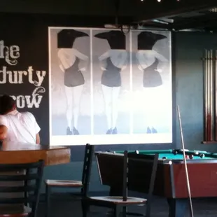 a woman sitting at a pool table