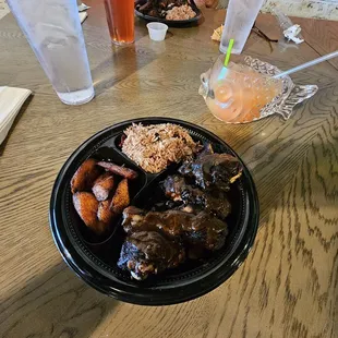Jerk chicken, rice and peas and plantain fries.