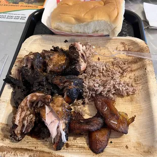 Jamaican Jerk chicken. Rice. Fried plantains. Coco Bread.