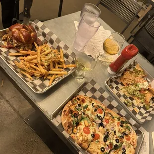 Beer cheddar burger, pesto flat bread, and nachos