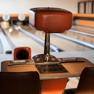 a bowling alley with bowling lanes in the background