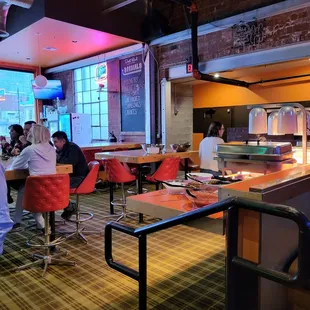 people sitting at tables in a restaurant