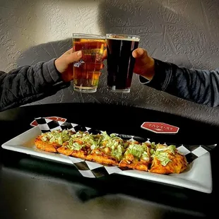 two people toasting with beer