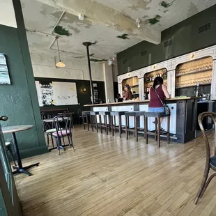 a woman standing at the bar