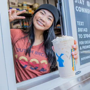 a woman holding a cup of coffee