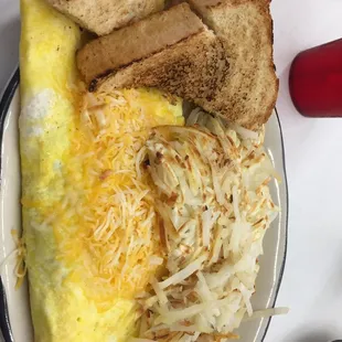 an omelet, toast, and hash browns