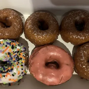 Brown cake white sprinkle, pumpkin donut, and Brown cake pink frosted