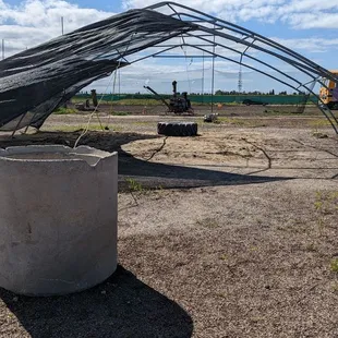 This structure is right in the middle of the lot, no idea what it used to be. Torn tarpaulin flutters in the breeze along with wire coils