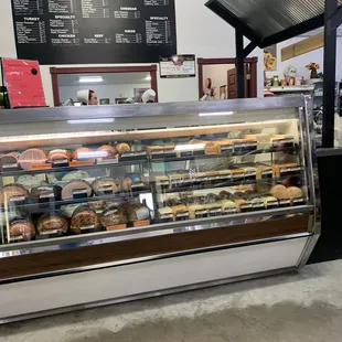 a deli counter with a variety of pastries