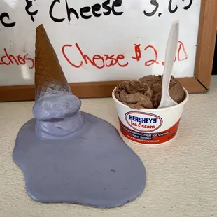 an ice cream cone and a scoop of ice cream