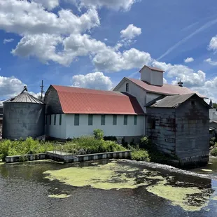 a view of a pond and silos