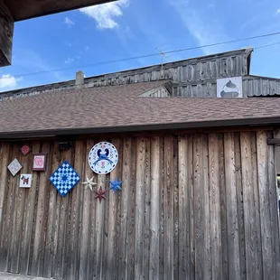 a wooden building with a clock on it