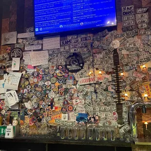 a bar with lots of stickers on the wall