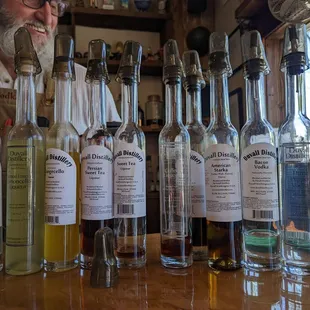 a man behind a bar filled with bottles of liquor