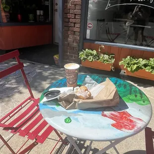 2 tables set out front 1 in sun and 1 in shade of a tree