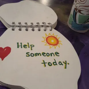 a sign that says help someone today