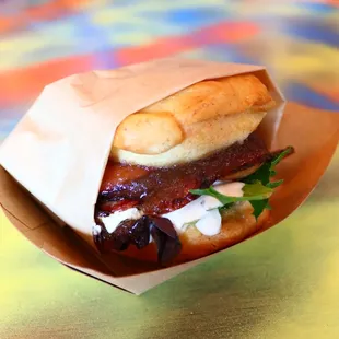 a sandwich wrapped in paper