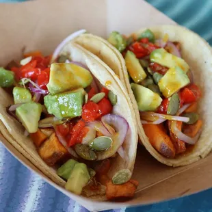 two tacos in a paper container