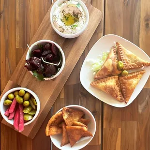 a wooden table with plates of food