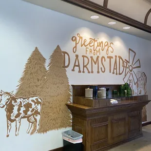 a farm scene with a cow and a windmill