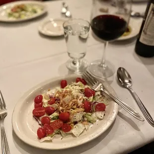 a plate of salad and a glass of wine