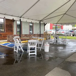 tables and chairs under a tent