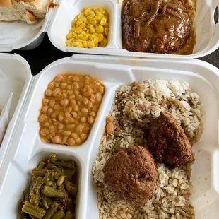 a tray of food with rice, beans, and meatballs