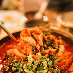 a bowl of food with chopsticks