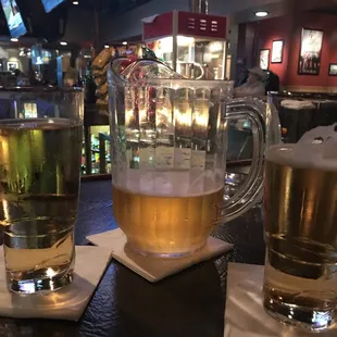 two glasses of beer on a bar