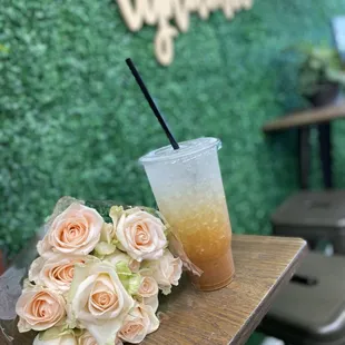 a cup of iced coffee and a bouquet of roses