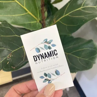 a hand holding a business card