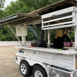 a man cooking food from a food cart