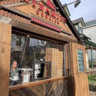 a woman behind the window of a restaurant