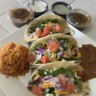 Steak n chicken Dynamite tacos with Refried beans and Spanish rice with there house made salsa