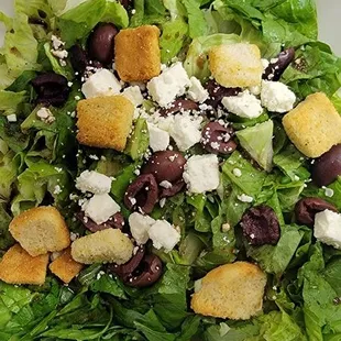 a salad in a styrofoam container