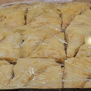 a tray of baked goods wrapped in plastic