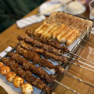 Quail eggs, Beef skewers, lamb skewers, rice cakes, enoki mushrooms