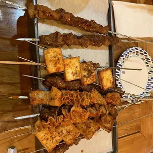 Attempted top to bottom: 2 lamb, 1 fish tofu, beef skewers underneath, 2 different tripe skewers on top, another skewer fish tofu