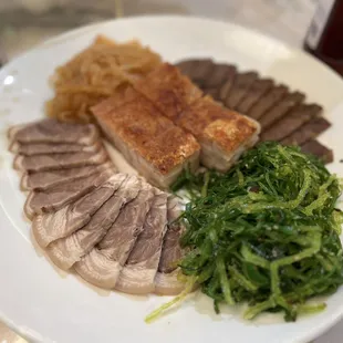 Appetizers: Sliced pig feet, Jellyfish, fried pork, sliced beef tongue, seaweed salad.