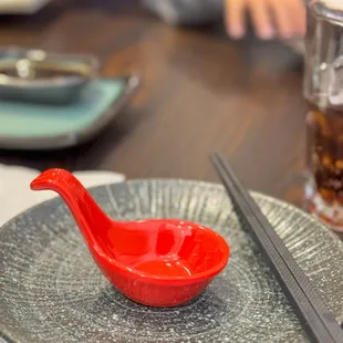  red bowl with chopsticks on a plate