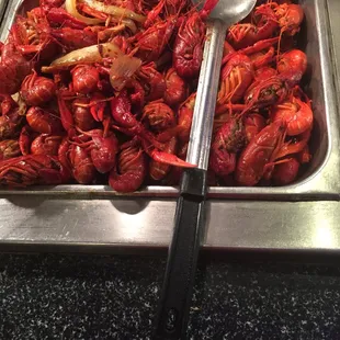 a tray of craws and a spoon