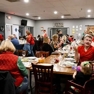 a large group of people sitting at a table