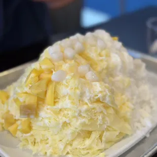 Plate order of mango and lychee.  Toppings mochi and mango and sweet condensed milk.