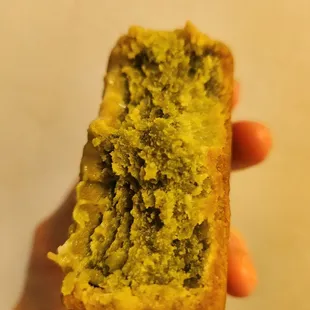 a hand holding a pastry