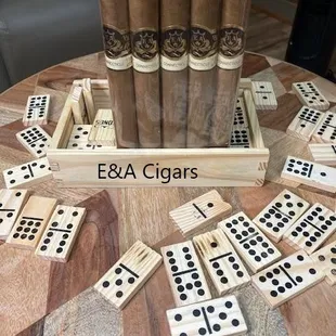 a table with dominos and cigars