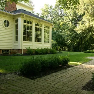 a brick path leading to a house